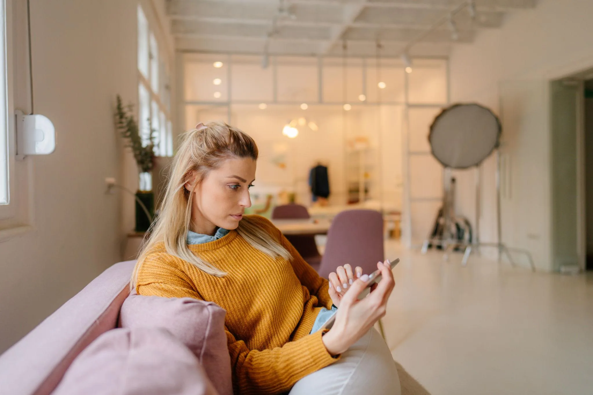 Woman booking home spa on phone